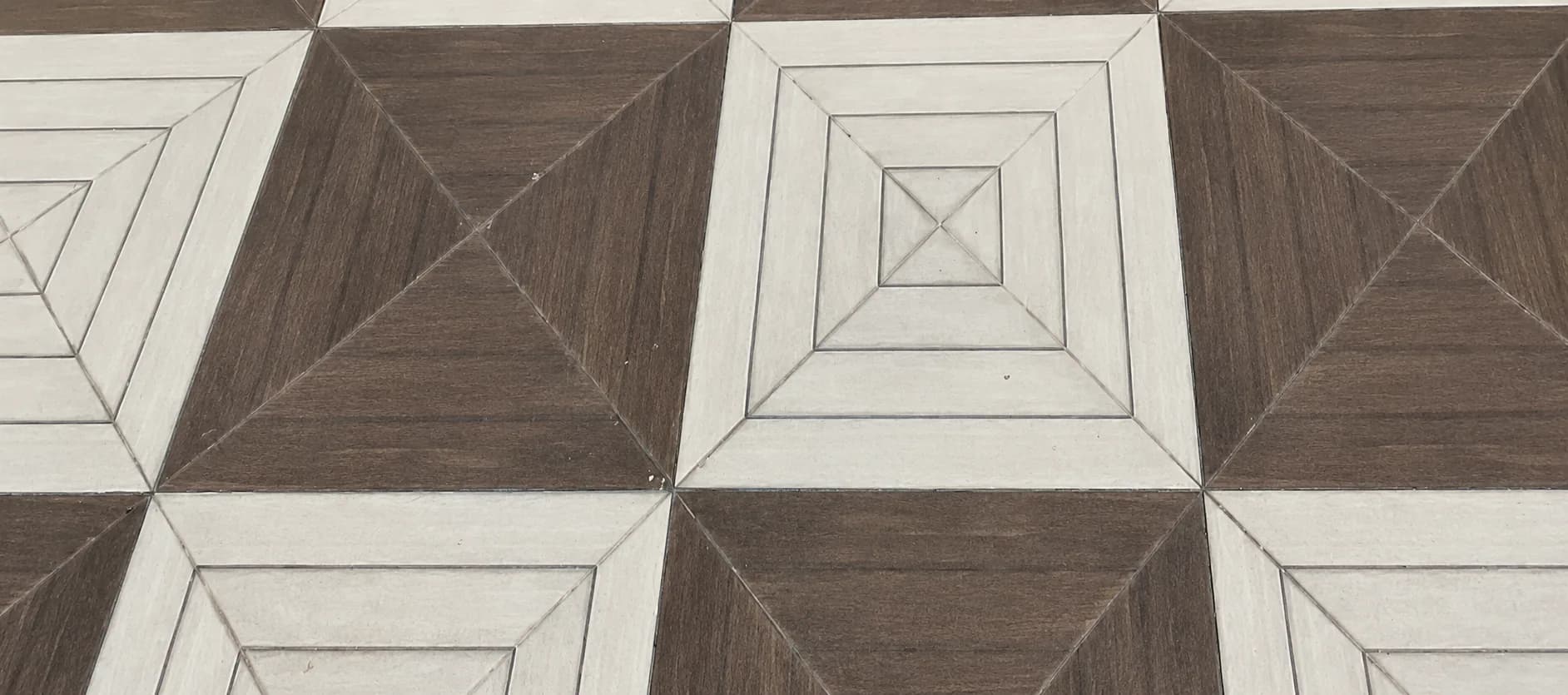 Close to the courtyard floor: brown and cream tiles set in nested squares